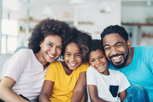 istock Smiling family with two children 1355999102