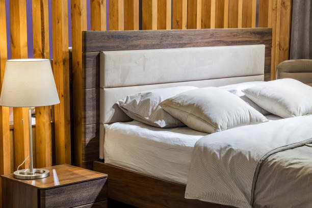 istock Bedroom interior, bed with pillows and blanket, lamp is on the bedside table 1355999183