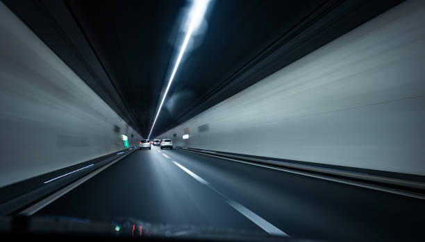 istock Cars on a highway going through a long modern tunnel 1355999798