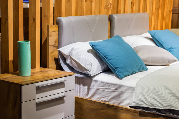 istock Bedroom interior, bed with pillows and blanket, lamp is on the bedside table 1355999800