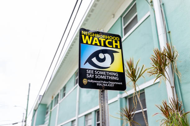 North Miami, Hollywood beach, Florida residential district near broadwalk and beach beachfront building with sign for Neighborhood watch closeup Hollywood, USA - August 4, 2021: North Miami, Hollywood beach, Florida residential district near broadwalk and beach beachfront building with sign for Neighborhood watch closeup neighborhood crime watch stock pictures, royalty-free photos & images