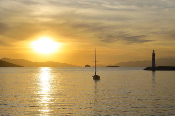 istock Alone sailboat at sunset. Atmospheric seascape with orange sun 1356001610