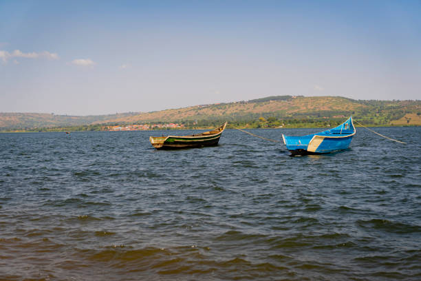 Fishing boat on Victoria Lakes. Jinja, Jinja, Uganda - 24 July 2021. 
A fishing boat is standing on near the pier of Lake Victoria. lake victoria stock pictures, royalty-free photos & images