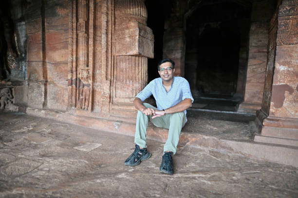 istock Man sitting in an ancient Hindu stone temple,  Badami, Karnataka 1356002015