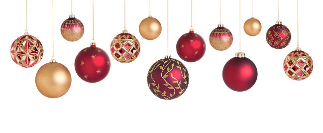 Red Christmas glitter ornament hanging on Christmas tree branch isolated on white background