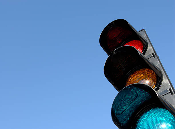 Close-up of traffic lights against blue sky stock photo
