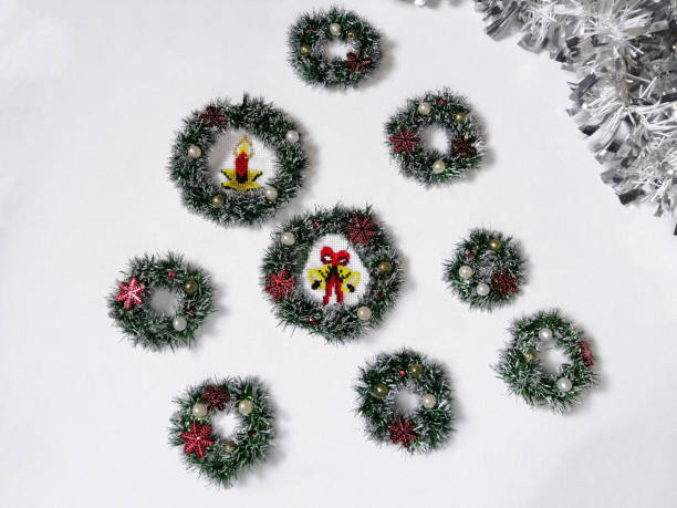 istock Miniature Christmas wreaths are empty and embroidered on a white background. 1356005126