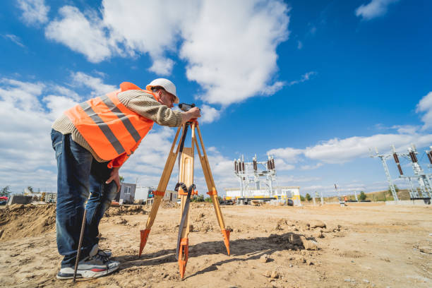 istock Surveyor worker with theodolite equipment at construction site 1356006077