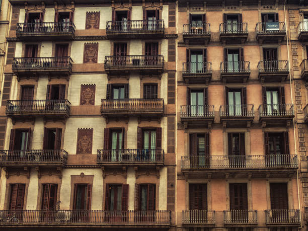 Geometric shapes of facade of modernist residential building with french balconies in Barcelona, Spain.