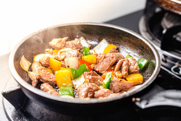 istock Cooking Raw Beef with belly chillies vegetables 1356007662
