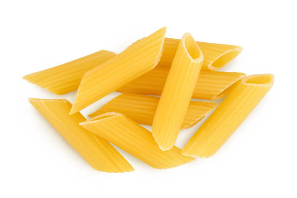 istock Raw italian penne rigate pasta isolated on white background with clipping path and full depth of field. Top view. Flat lay 1356008986
