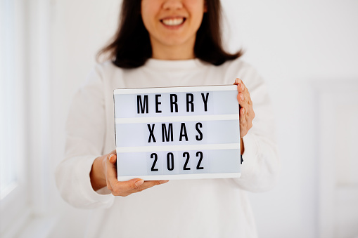 Woman Holding Merry Christmas text