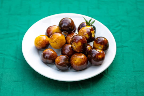 istock fresh cherry tomatoes of different varieties on a plate on the blurred background, closeup 1356013765