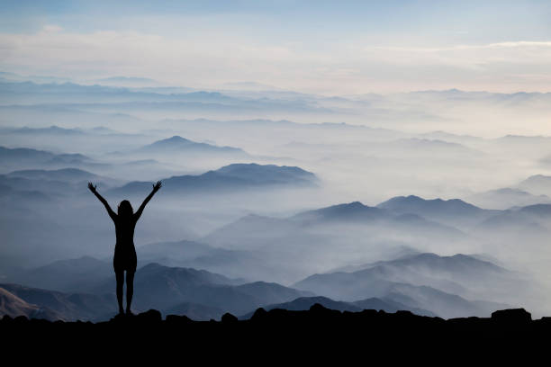 istock Woman Silhouette at sunset on hill 1356013946