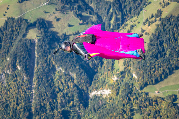 istock Man in wingsuit glides through clear skies 1356014207