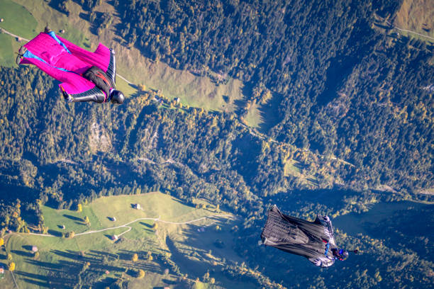 istock Man in wingsuit glides through clear skies 1356014385