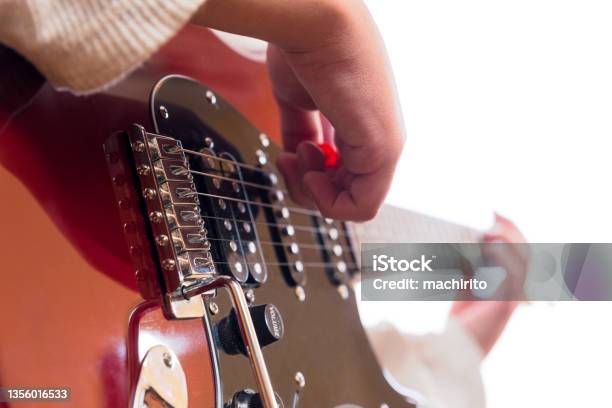 Tremolo And Strings Of An Electric Guitar Played By A Young Guitarist On A White Background And Selective Focus Stock Photo - Download Image Now