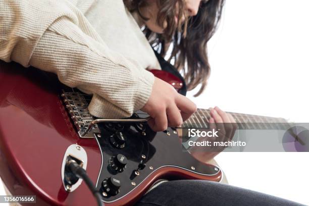 Young Man Moves The Tremolo Of His Guitar While Playing The Guitar To Practice His Music Studies Stock Photo - Download Image Now