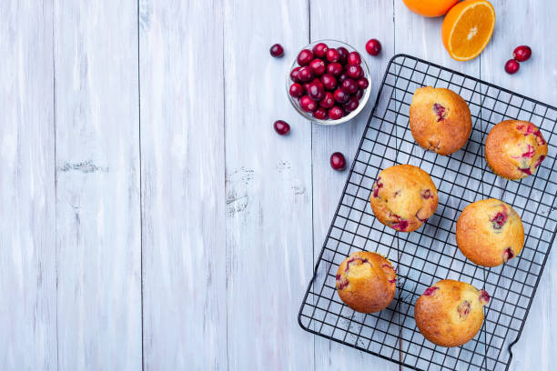 istock Cranberry orange muffins on cooling rack, horizontal, top view, copy space 1356017839