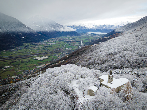 the church of Boggio during the first seasonal snowfall, photo taken with drone.