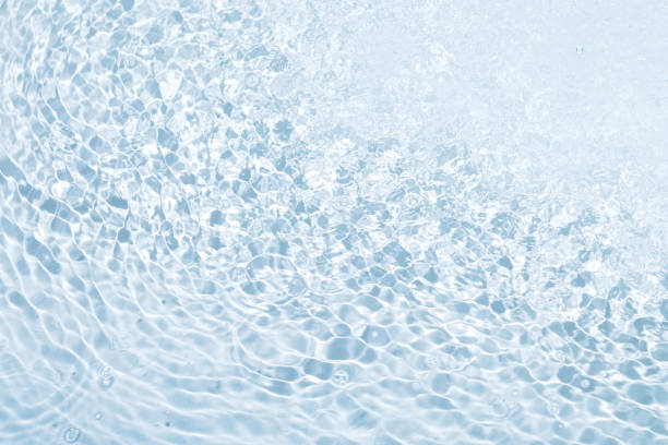 istock Seething blue water background with splashes and bubbles on the surface 1356018458