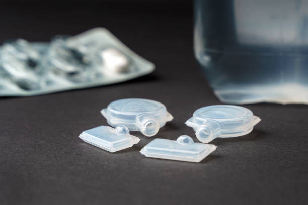 istock Used plastic containers for liquid medicines lie on a dark surface. 1356019336