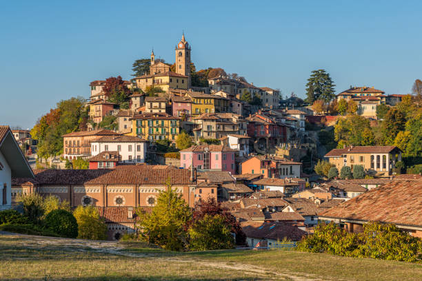 Panoramic sight of Monforte d'Alba village during fall season. Langhe region of Piedmont, Cuneo, Italy. Panoramic sight of Monforte d'Alba village during fall season. Langhe region of Piedmont, Cuneo, Italy. cuneo stock pictures, royalty-free photos & images