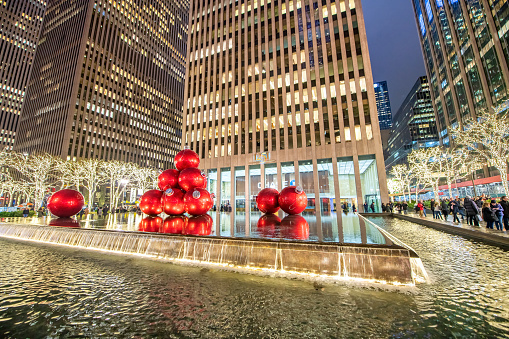 New York City - November 30th, 2018: Giant red Christmas Balls over a fountain in front of Chase Bank at night