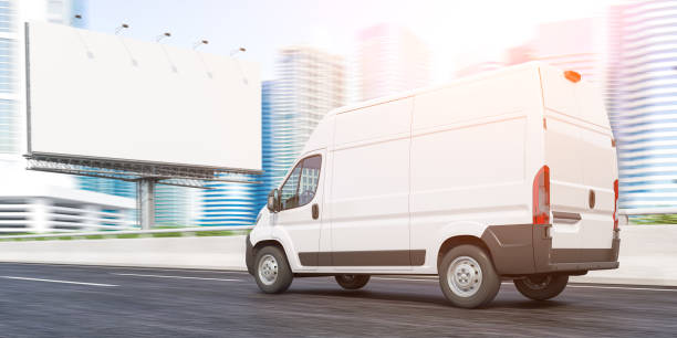 istock Delivery van moving to downtown skyscrapers and empty billboard. Express delivery and moving. 1356024802