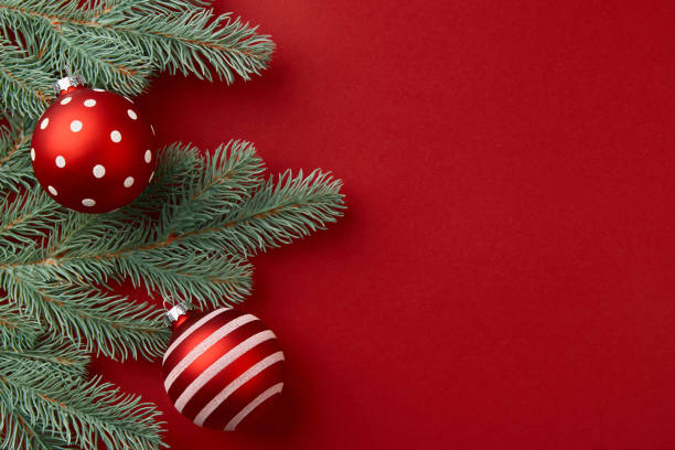 istock Christmas composition. Christmas tree branches and ornaments on red background 1356027132