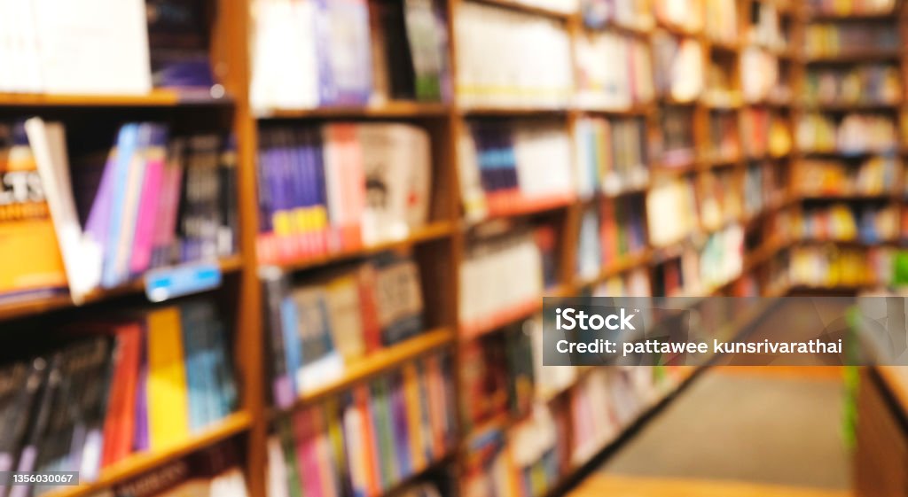 Blur background of book shelf store decorated with wood and warm light Bookstore Stock Photo
