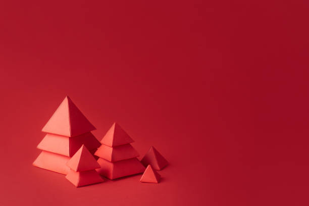 istock Five red Christmas trees made of paper on red background. 1356030713