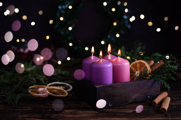 istock Four purple burning advent candles, Christmas eve. 1356030780
