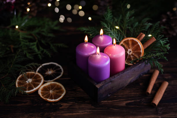 istock Christmas eve, four purple burning advent candles. 1356031328