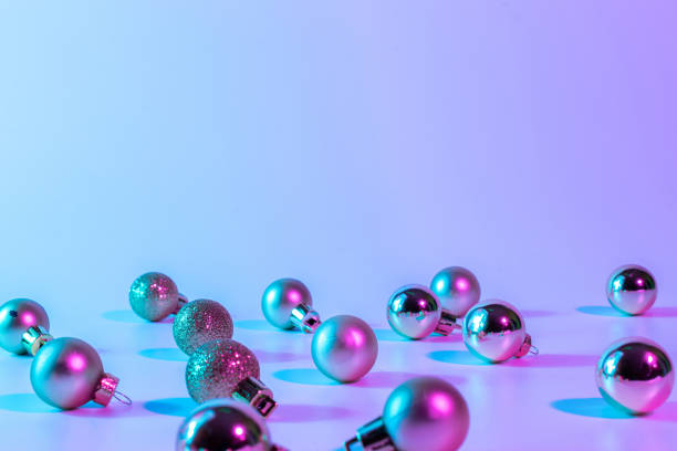 istock Christmas balls pattern neon background. Xmas bauble on abstract holiday winter gradient backdrop. Happy new year copy space. 1356035061