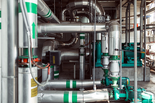 Interior of Industrial Gas Boiler House With Many Pipes, Boilers and other Industrial Equipment.