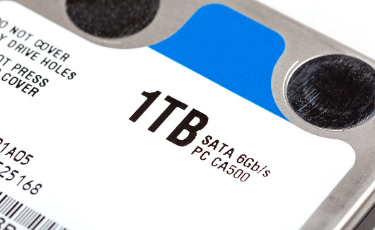 1 TB hard drive storage space , simple one terabyte 2.5 inch HDD object macro, extreme closeup, number label, nobody, detail shot. Hard disk digital data capacity, 1000 gb drive size simple concept