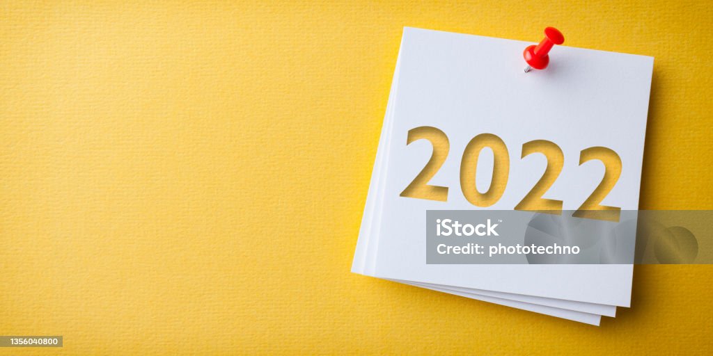 White Sticky Note With Happy New Year 2022 And Red Push Pin On Yellow Background 2022 Stock Photo