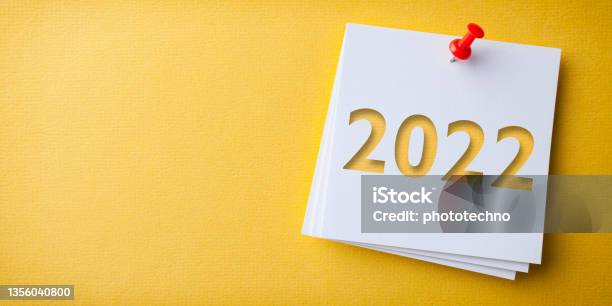 White Sticky Note With Happy New Year 2022 And Red Push Pin On Yellow Background Stock Photo - Download Image Now