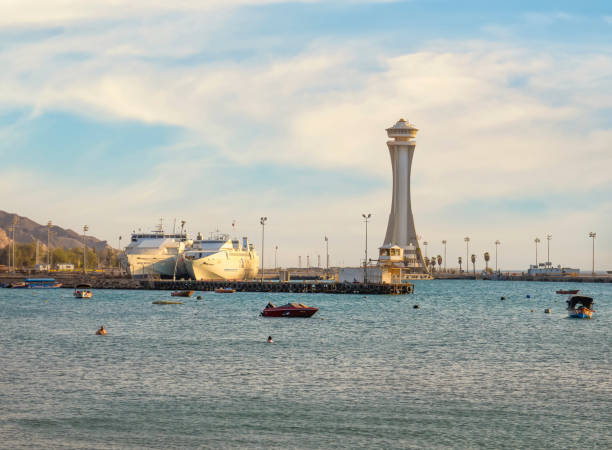 Scenic view at sunset with Aqaba Port Observation or control Tower, Jordan. Lighthouse at sunset Aqaba, Jordan - 09.01.2021: Scenic view at sunset with Aqaba Port Observation or control Tower, Jordan. Lighthouse at sunset akaba stock pictures, royalty-free photos & images