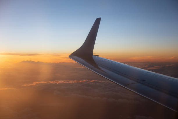 istock Dusk above clouds through the airplane window 1356046084