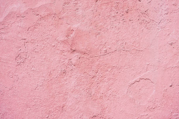 istock Concrete pink background with cracks, scuffs and splashes. Wall texture, delicate color 1356046426