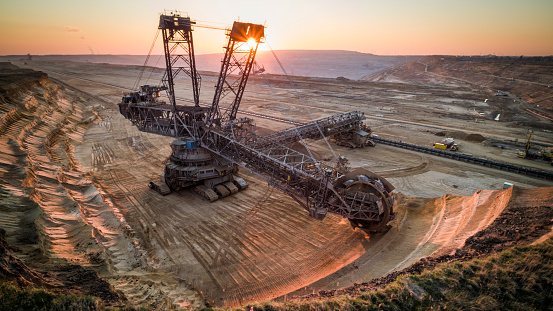 Aerial view of  a back lit Bucket Wheel Excavators working in a lignite surface mine at sunset.