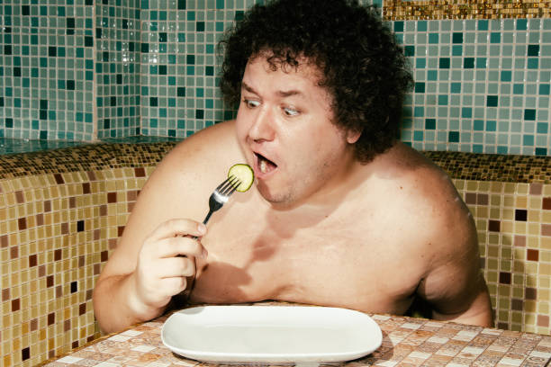 istock Funny fat man on a diet. 1356050372