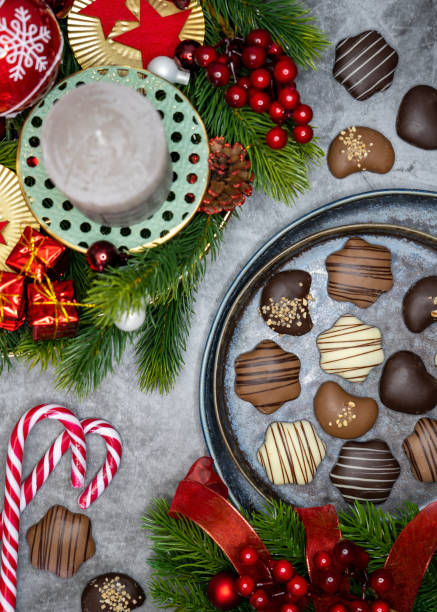 istock Christmas wreath and different Christmas sweets, chocolate biscuits on table. 1356050529