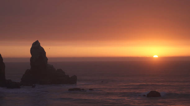 istock golden hour at sea with rock island 1356050918