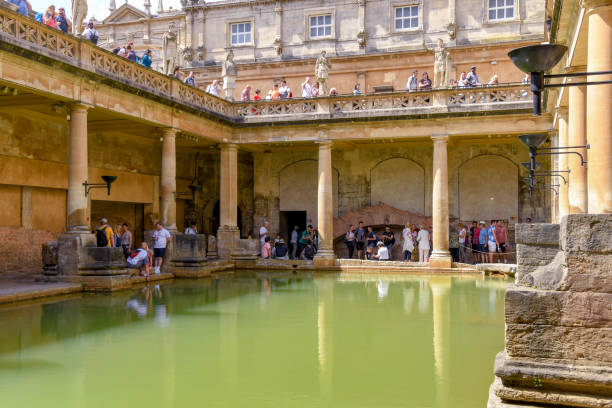 Bath, England - July 2019: People visiting the Roman Baths in the centre of Bath