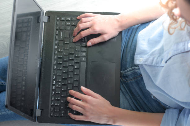 istock Young woman workng on laptop computer 1356054017