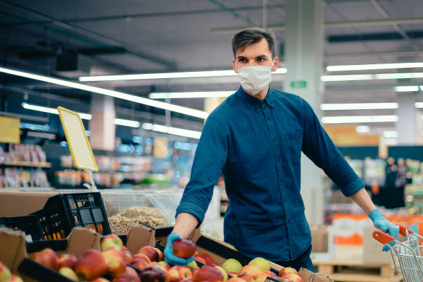 istock young man with a shopping cart picking apples 1356054762
