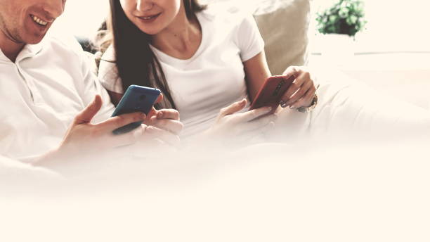 istock happy young couple looking at their smartphone screen 1356054908